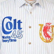 Close-up of a shirt with 'Colt 45 Works Every Time' text and logo.