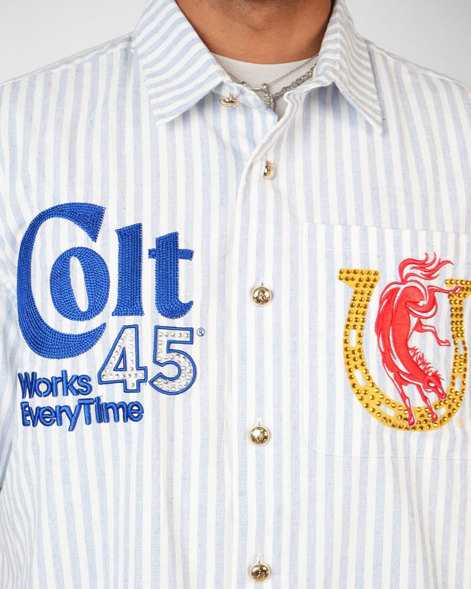 Close-up of a shirt with 'Colt 45 Works Every Time' text and logo.