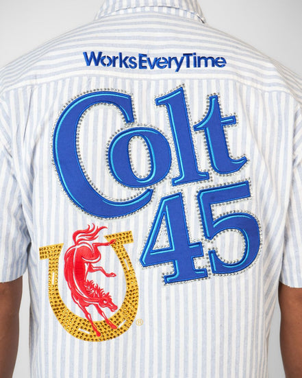 Back view of a shirt with 'Colt 45' branding and text on a white background