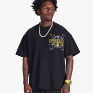 Man wearing a black t-shirt with yellow text on a white background