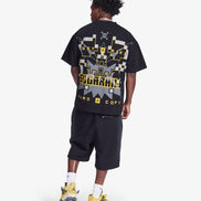 Person wearing a black t-shirt with graphic design and text, standing on a white background