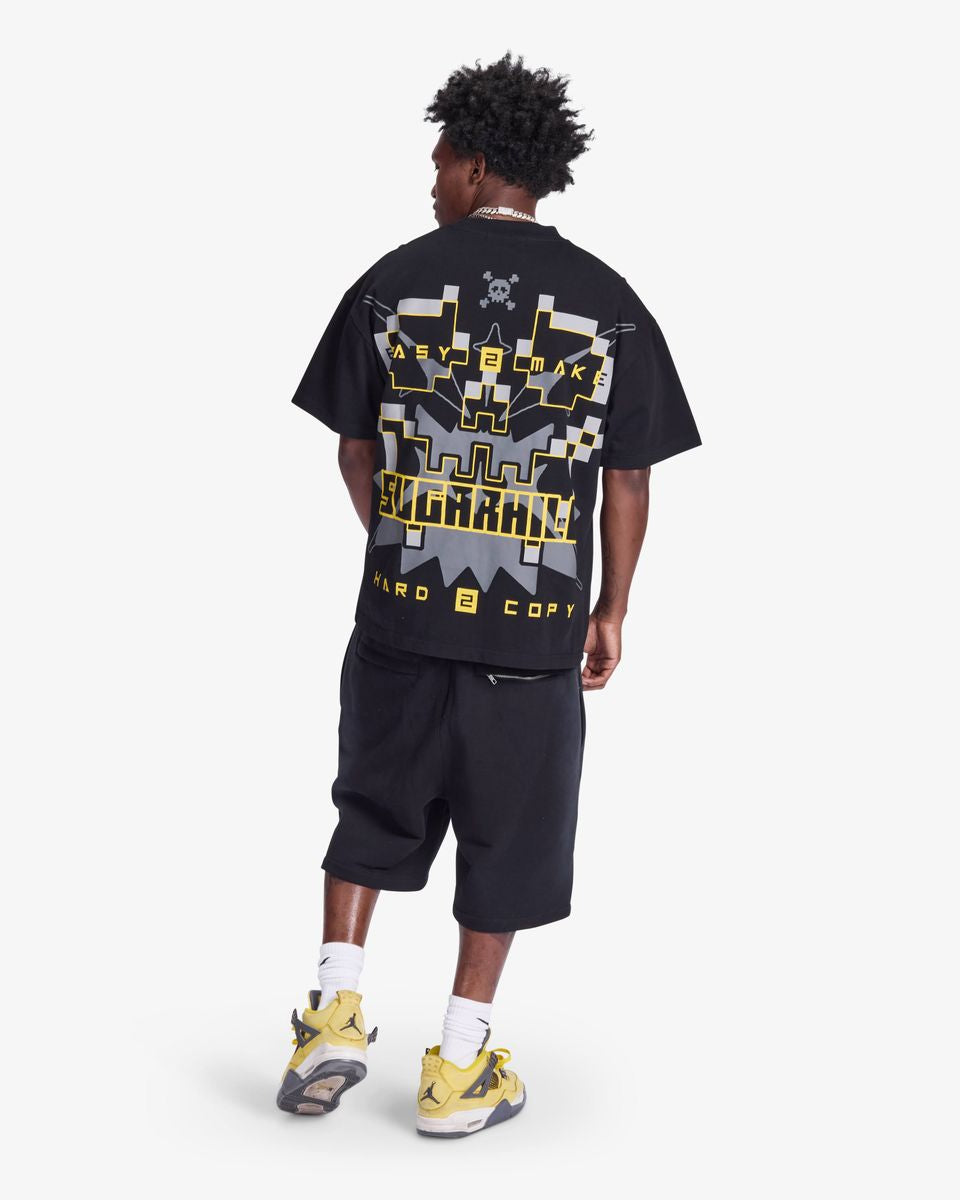 Person wearing a black t-shirt with graphic design and text, standing on a white background