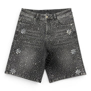 Black denim shorts with white floral patterns on a white background