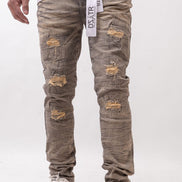 Person wearing distressed gray jeans with a white background