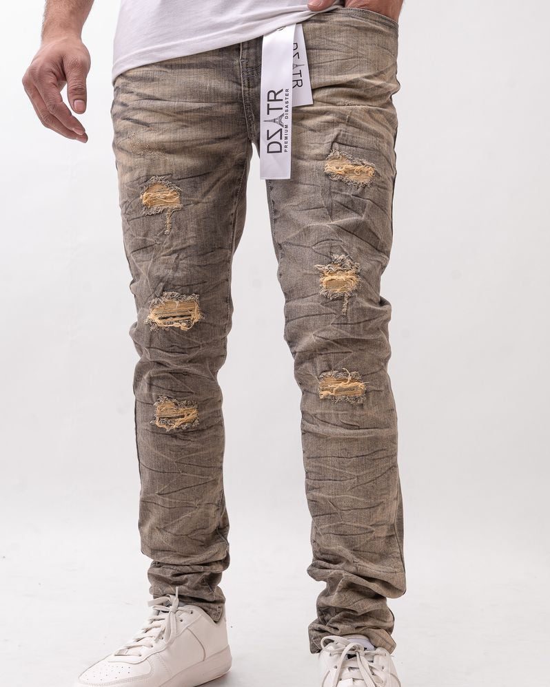 Person wearing distressed gray jeans with a white background