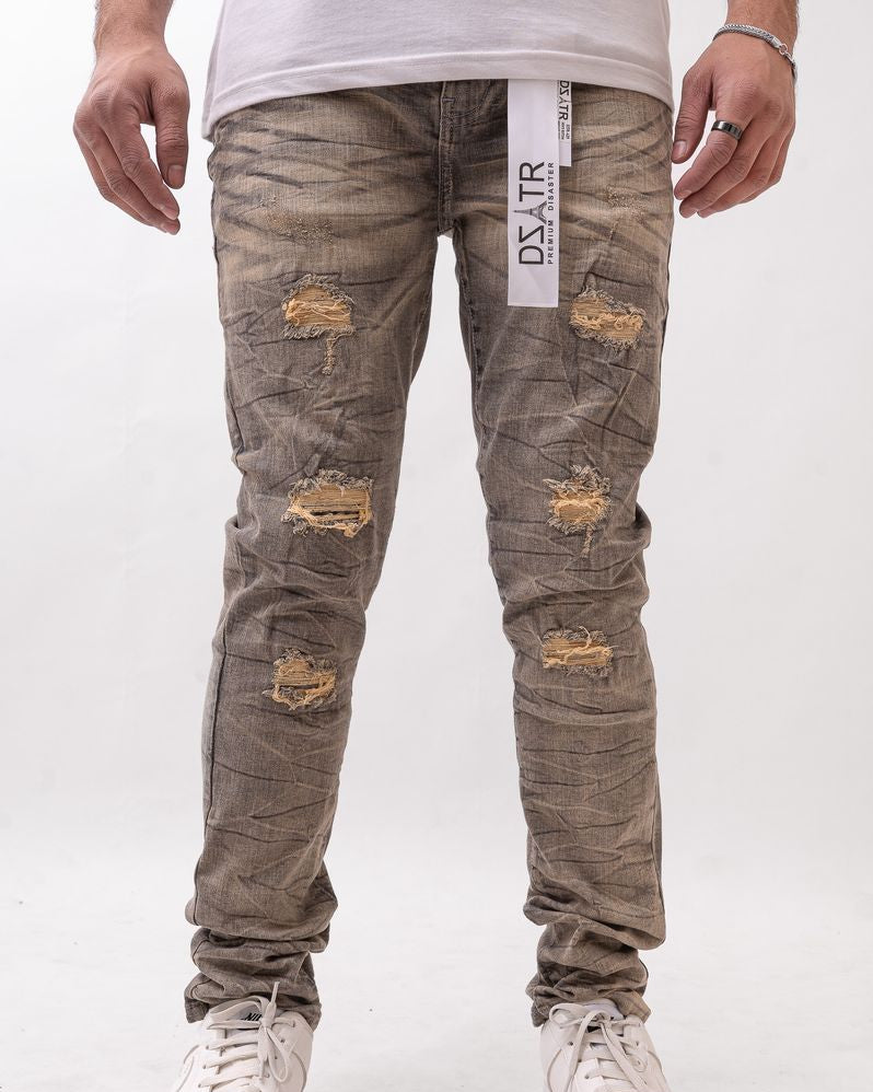 Distressed gray jeans with brand label on a white background