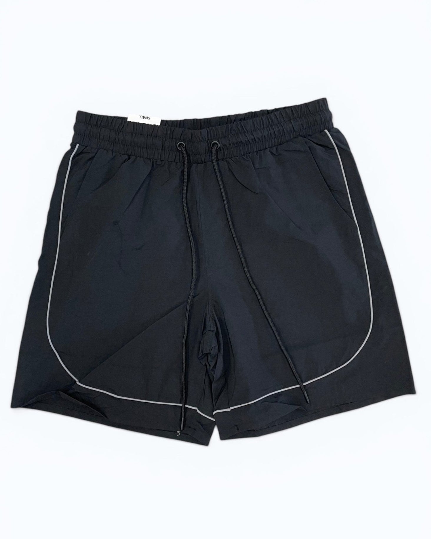 Black shorts with white piping on a white background