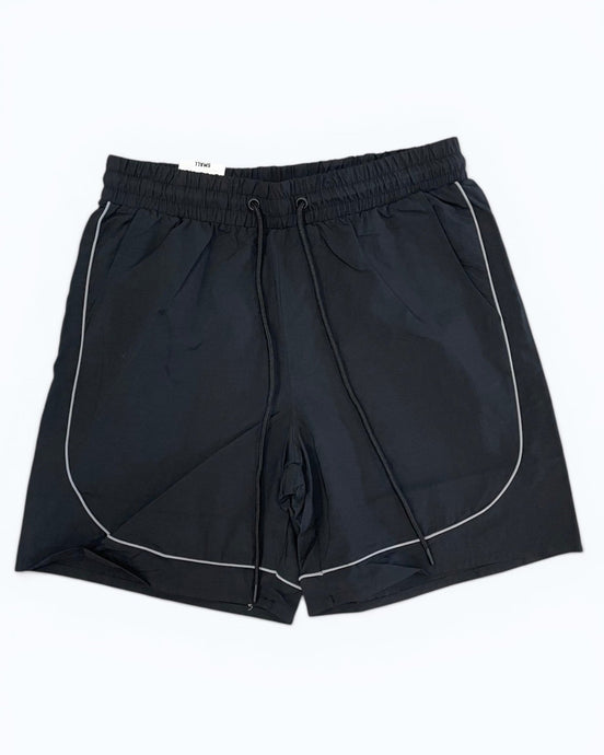 Black shorts with white piping on a white background