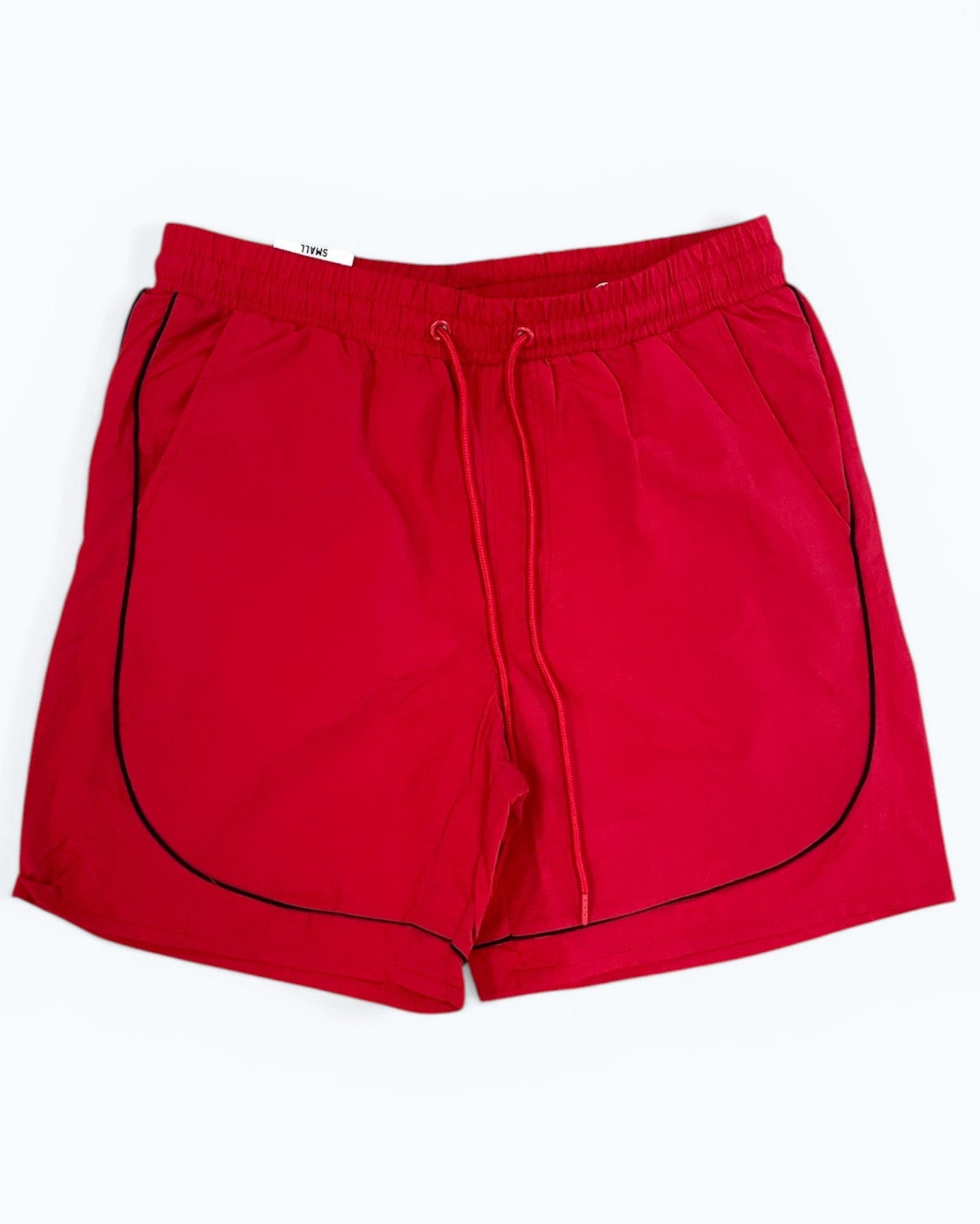 Red shorts with black piping on a white background