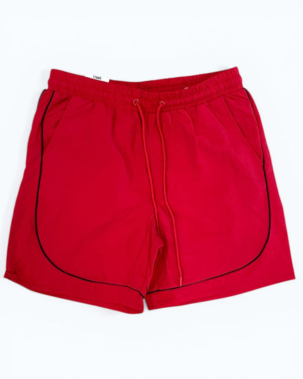 Red shorts with black piping on a white background