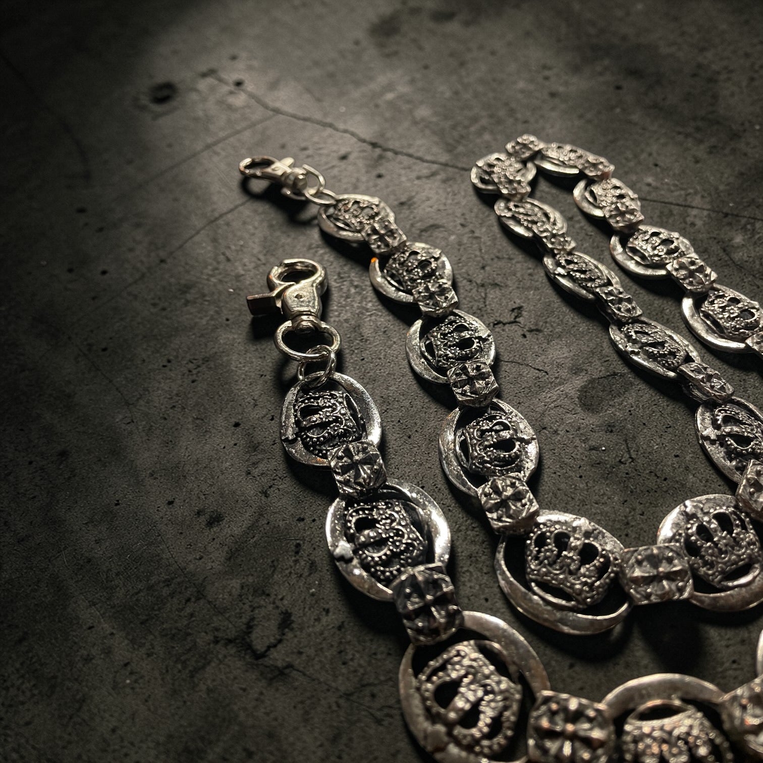 Silver WALLET chain on a textured dark surface