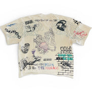 Beige t-shirt with graphic designs and text on a white background