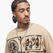 Man wearing a beige t-shirt with graphic designs on a white background