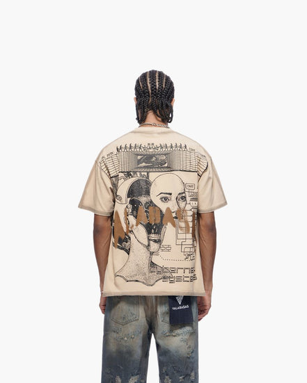 Person wearing a beige t-shirt with graphic design on the back, standing against a white background