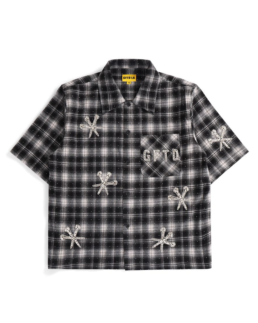 Black and white plaid shirt with embroidered designs on a white background