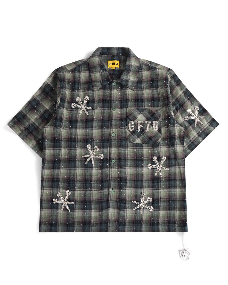 Plaid shirt with embroidered designs and text on a white background