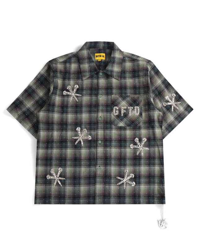 Plaid shirt with embroidered designs and text on a white background