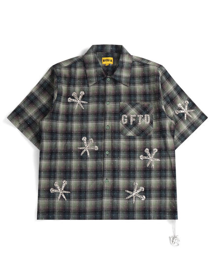 Plaid shirt with embroidered designs and text on a white background