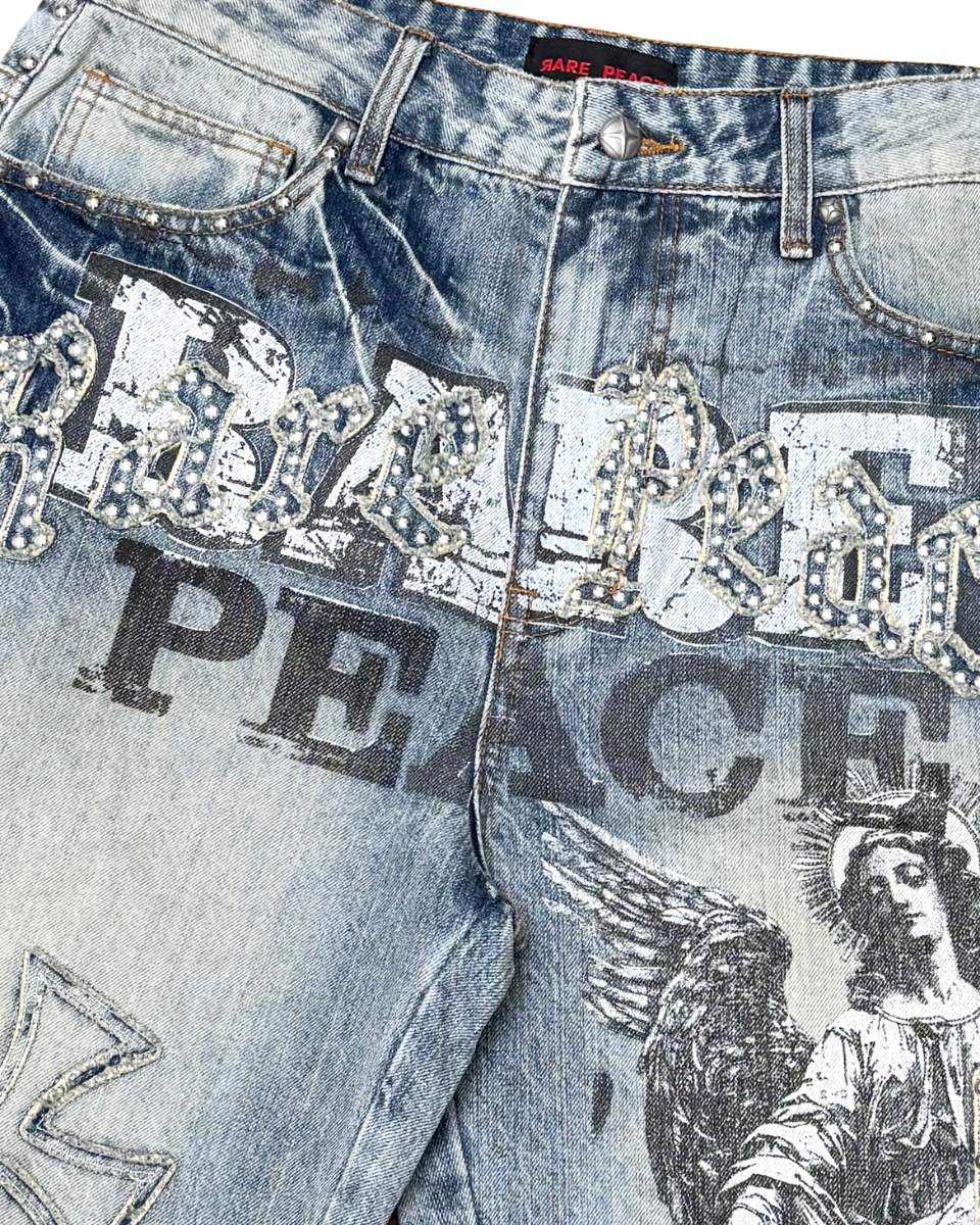 Close-up of blue jeans with embellishments and text