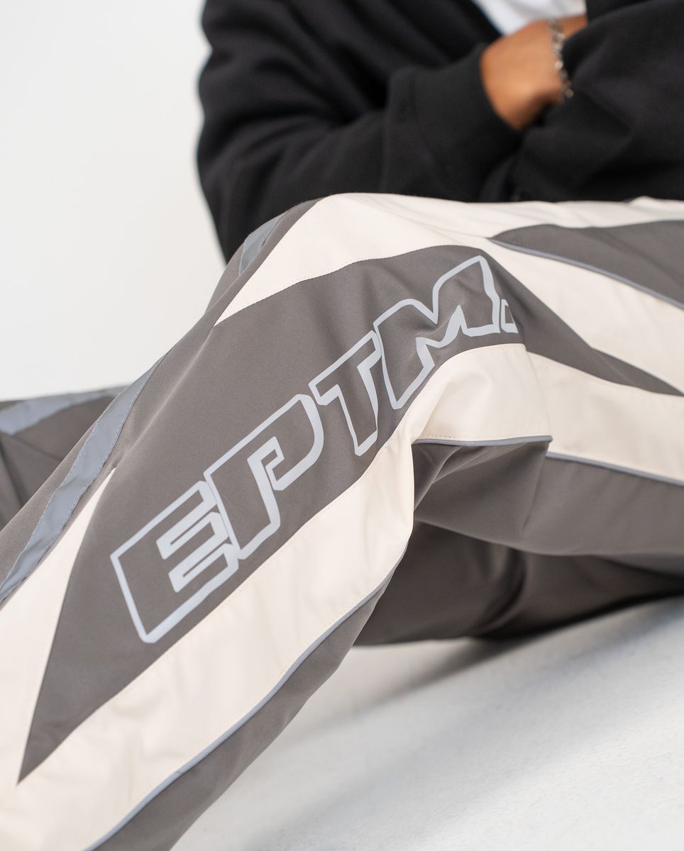 Close-up of a gray and white jacket with 'EPTM' branding.
