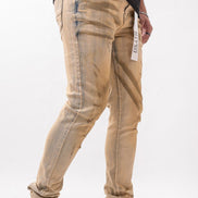 Beige distressed jeans worn by a person on a white background