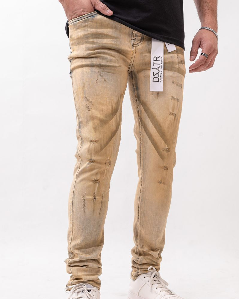 Beige distressed jeans worn by a person on a white background