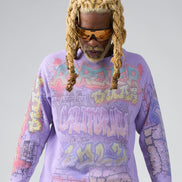 Person wearing a purple graphic sweatshirt with colorful text and designs on a gray background