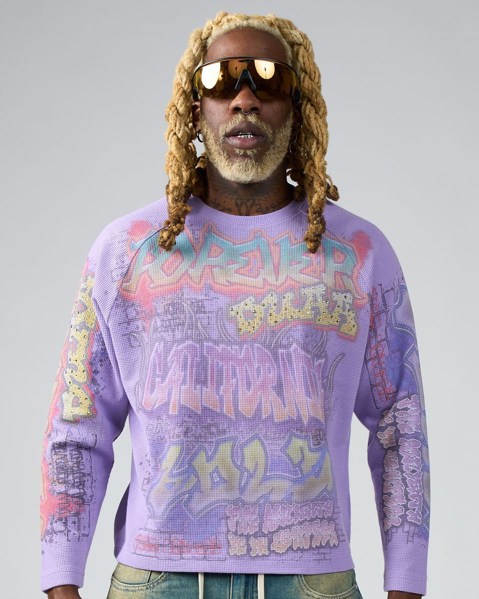 Person wearing a colorful sweater with text and graphics on a gray background