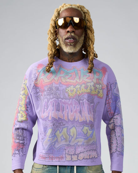 Person wearing a colorful sweater with text and graphics on a gray background