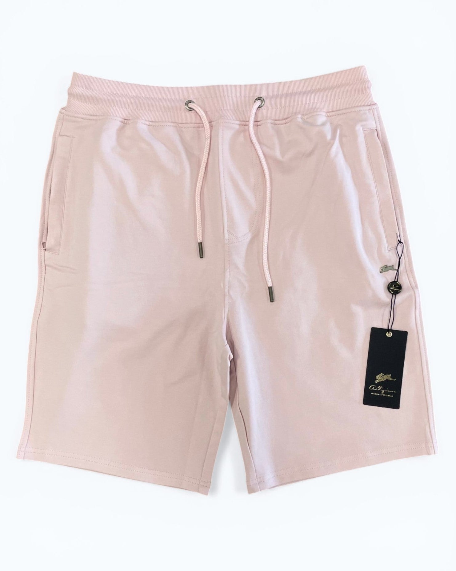 Pink shorts with a drawstring and brand tag on a white background