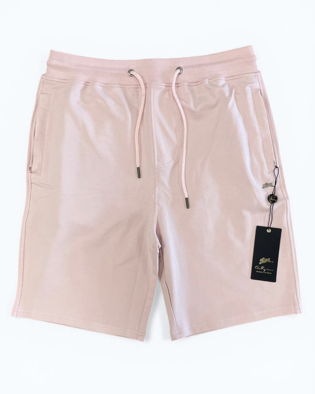 Pink shorts with a drawstring and brand tag on a white background