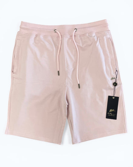 Pink shorts with a drawstring and brand tag on a white background