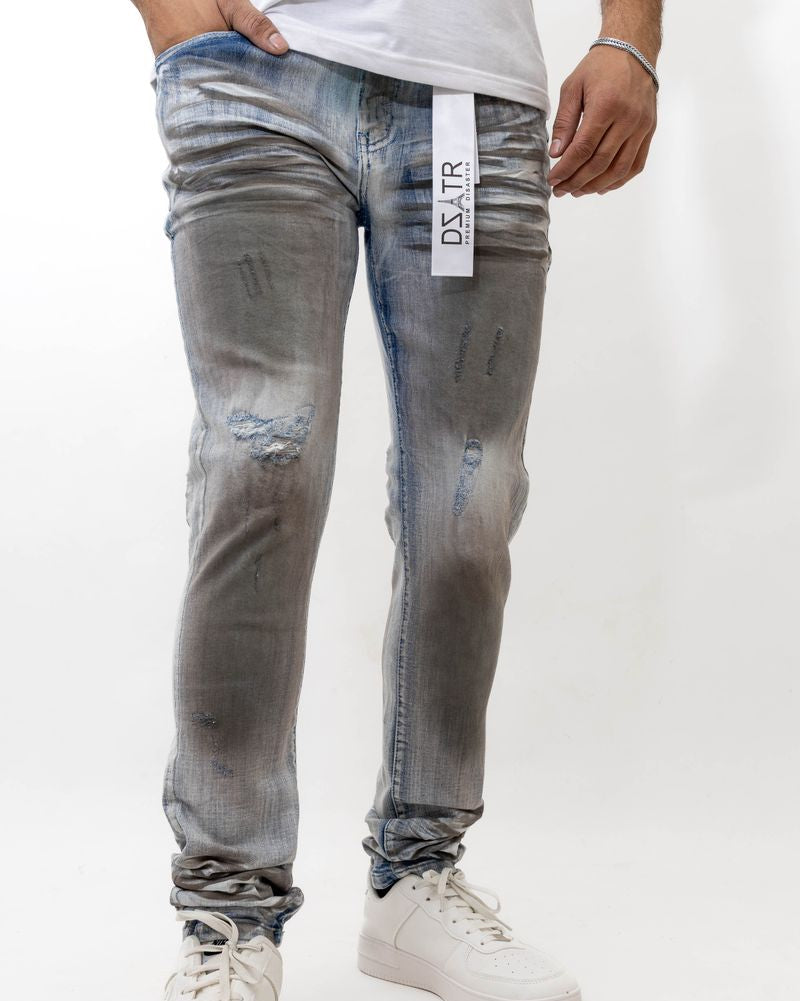 Person wearing distressed gray jeans with a visible brand label on a white background