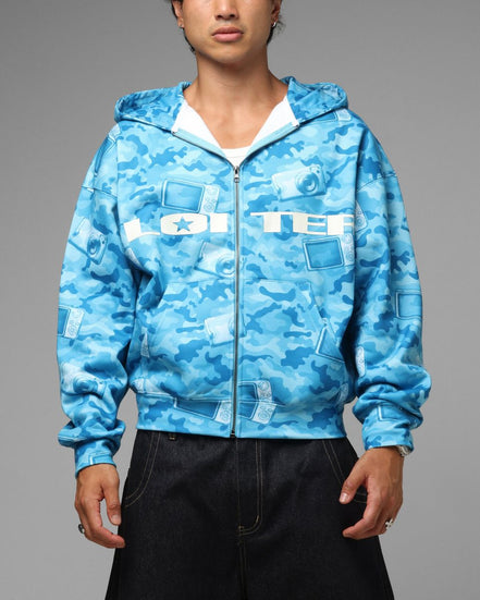 Person wearing a blue camouflage hoodie with 'LOITER' branding on a gray background