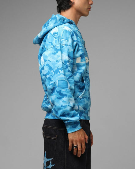 Person wearing a blue camouflage hoodie on a gray background