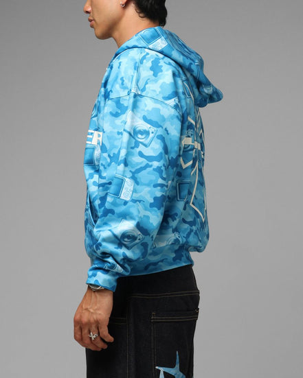 Person wearing a blue camouflage jacket on a gray background