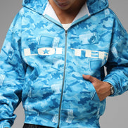 Person wearing a blue camouflage hoodie with 'LOTER' branding on a gray background