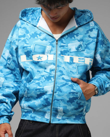 Person wearing a blue camouflage hoodie with 'LOTER' branding on a gray background