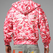 Person wearing a pink and white camouflage jacket on a gray background