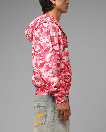 Person wearing a pink camouflage jacket on a gray background