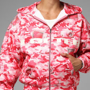 Person wearing a pink camouflage jacket on a gray background