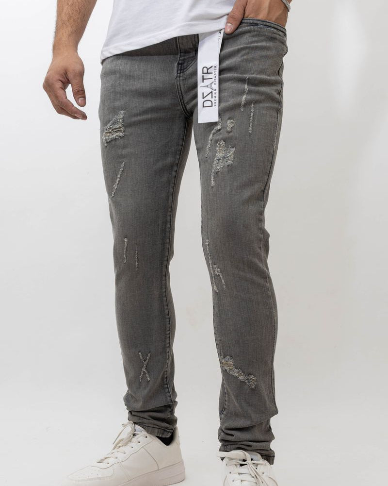 Person wearing gray distressed jeans with a white background