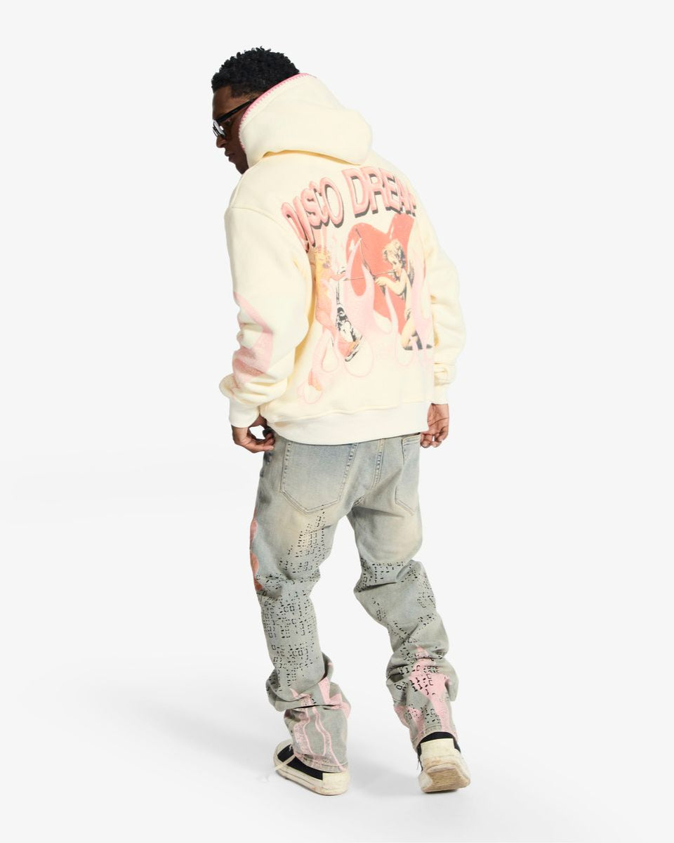 Person wearing a light-colored hoodie with text and graphics on the back, standing against a white background.