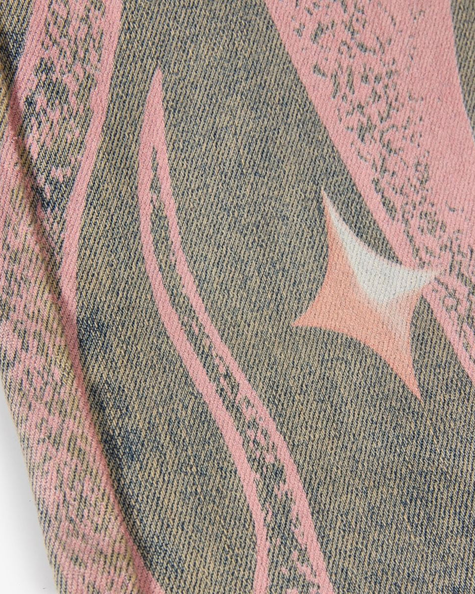 Close-up of a fabric with pink abstract patterns on a textured background