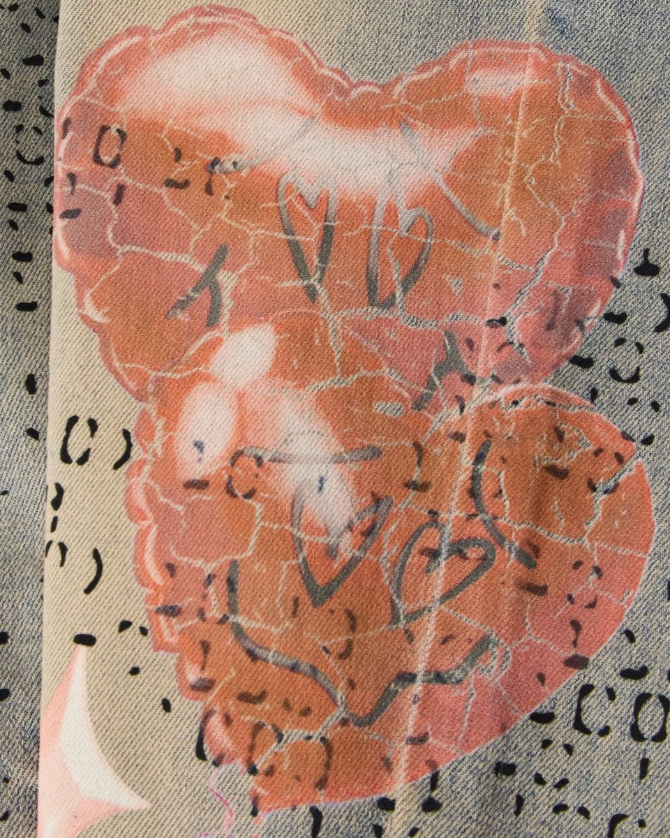 Heart-shaped object with decorative elements on a textured background
