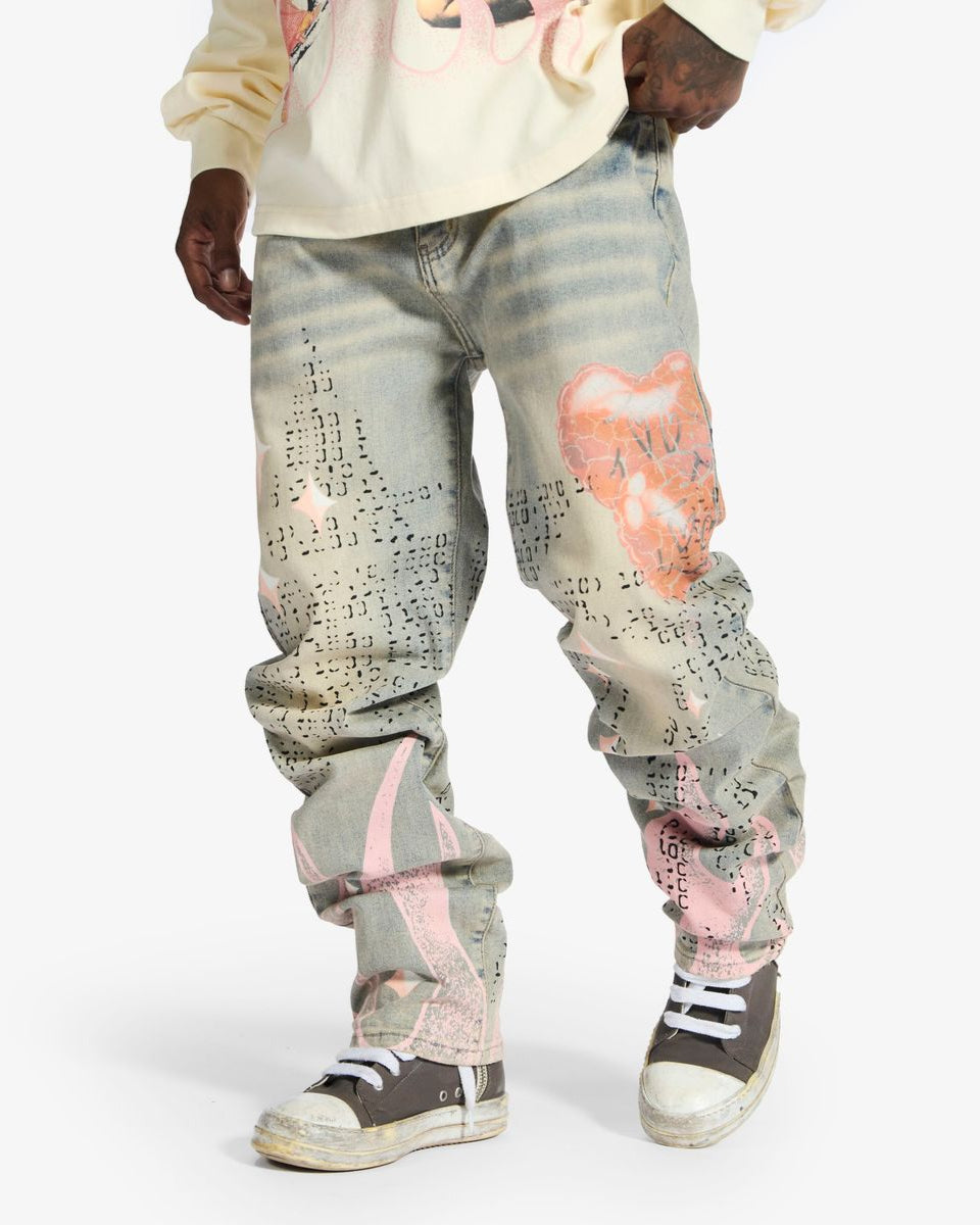 Person wearing light gray pants with pink and black designs on a white background