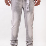 Person wearing gray jeans with a brand label on a white background