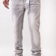 Person wearing light gray jeans with a visible brand logo on a white background