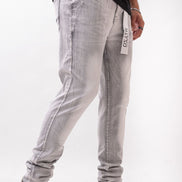 Person wearing light gray pants with a white background 