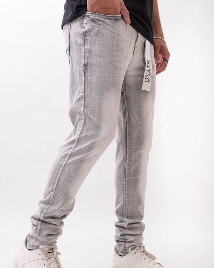 Person wearing light gray pants with a white background 